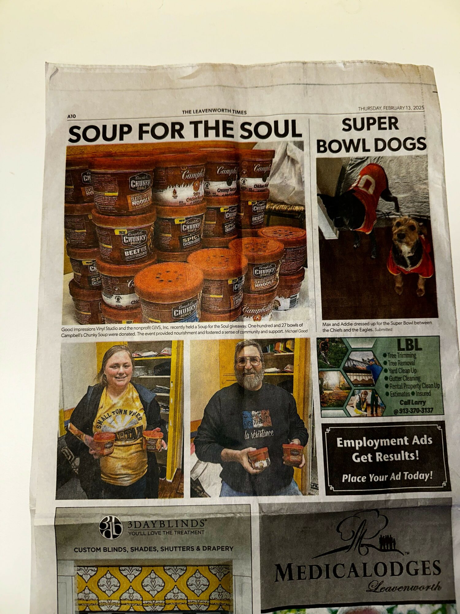 Newspaper page with images of food jars, a person speaking, and a person holding a drink, with headlines and advertisements.