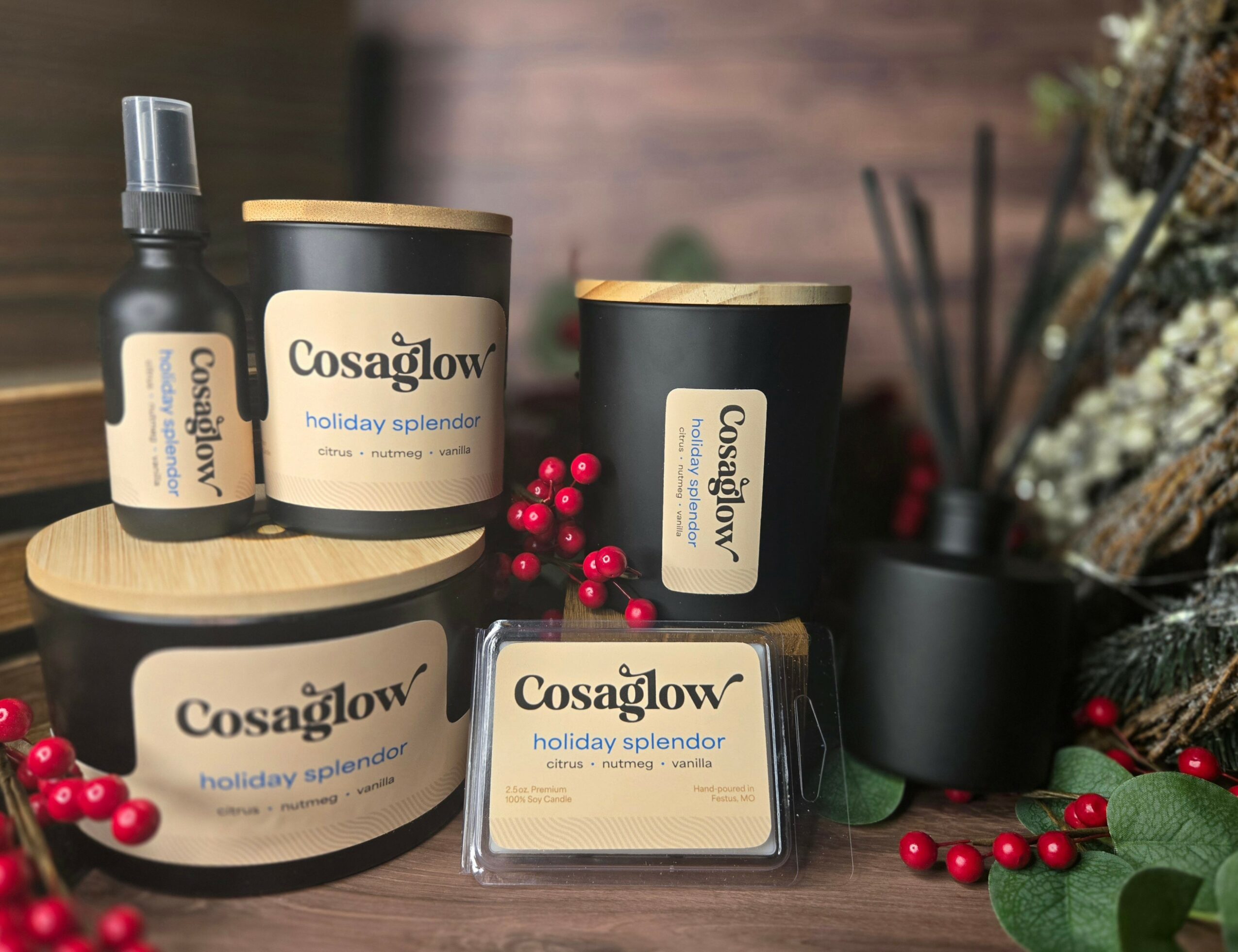 Collection of Cosaglow holiday skincare products with red berries and decorative plants on a wooden surface.