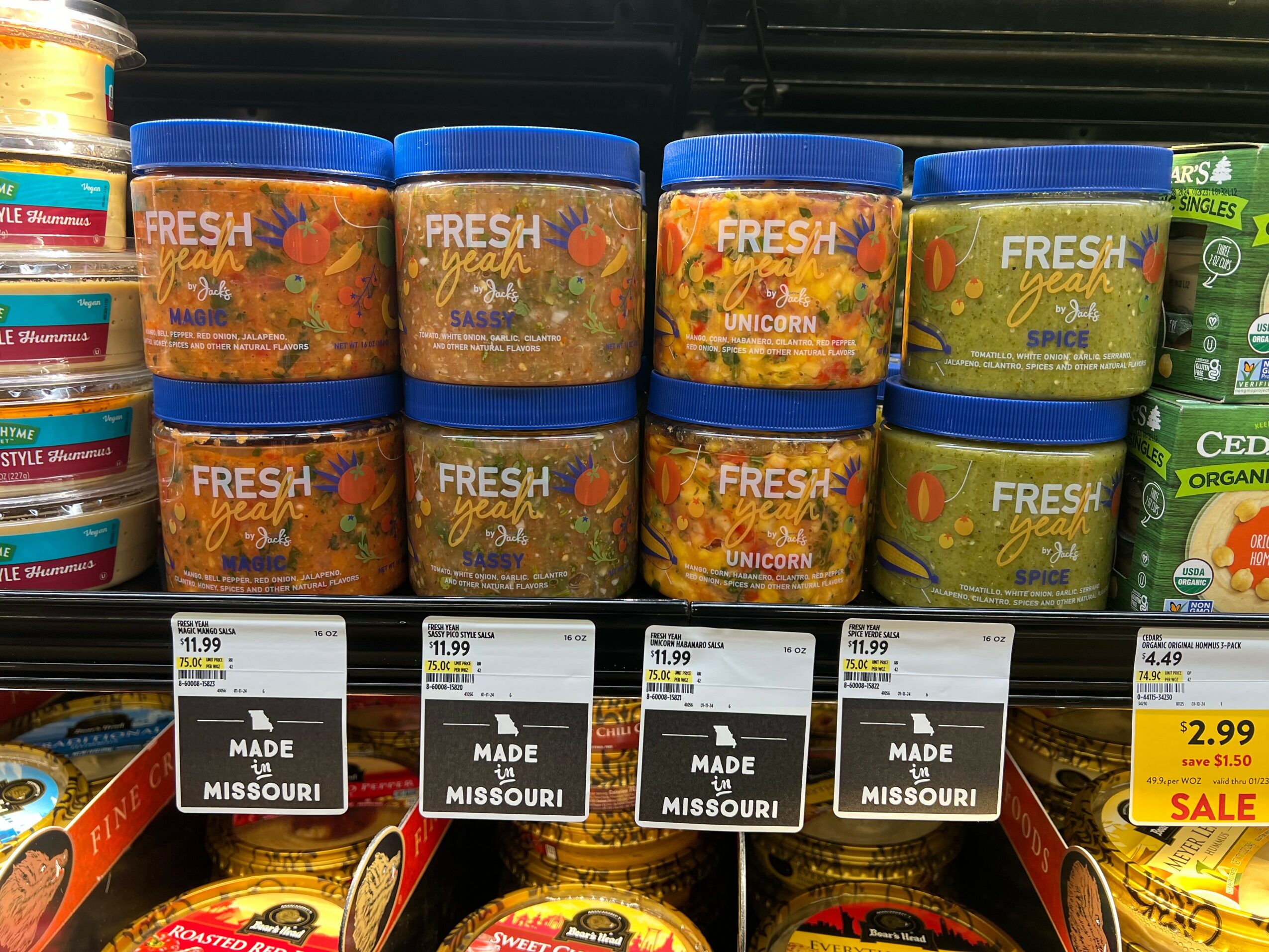 Containers of fresh unicorn-themed snack mix on store shelf with price tags below, some marked as sale.