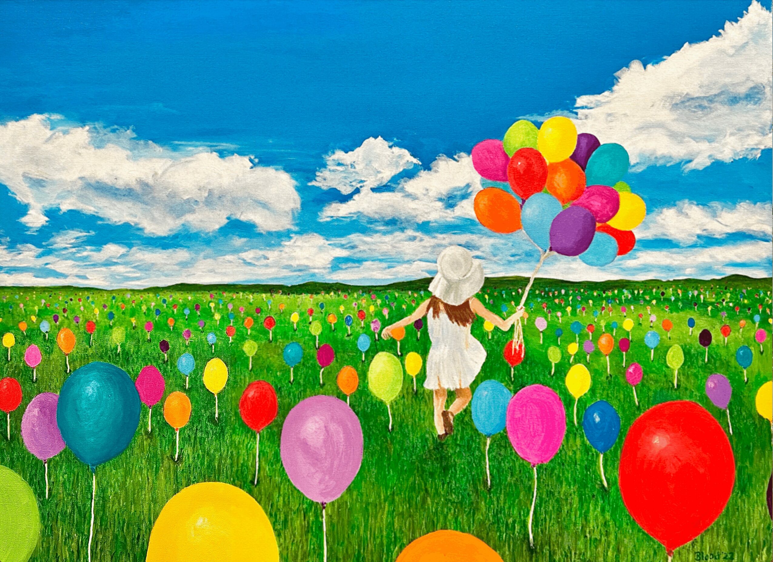 Child in white dress holding a bunch of colorful balloons in a field with many balloons and a blue sky with clouds.