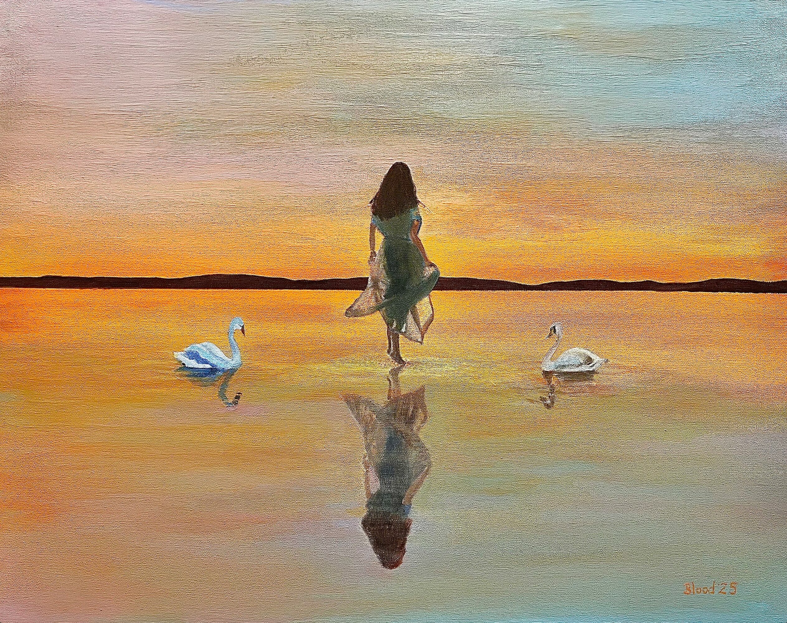 A woman stands in shallow water at sunset, with two swans nearby and her reflection visible in the water.