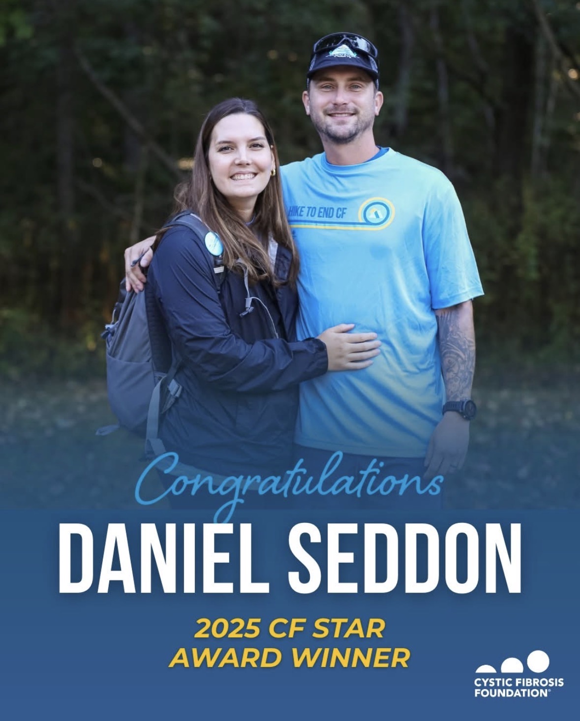 A smiling young woman and man stand outdoors with trees in the background, celebrating Daniel Seddon's CF star award.