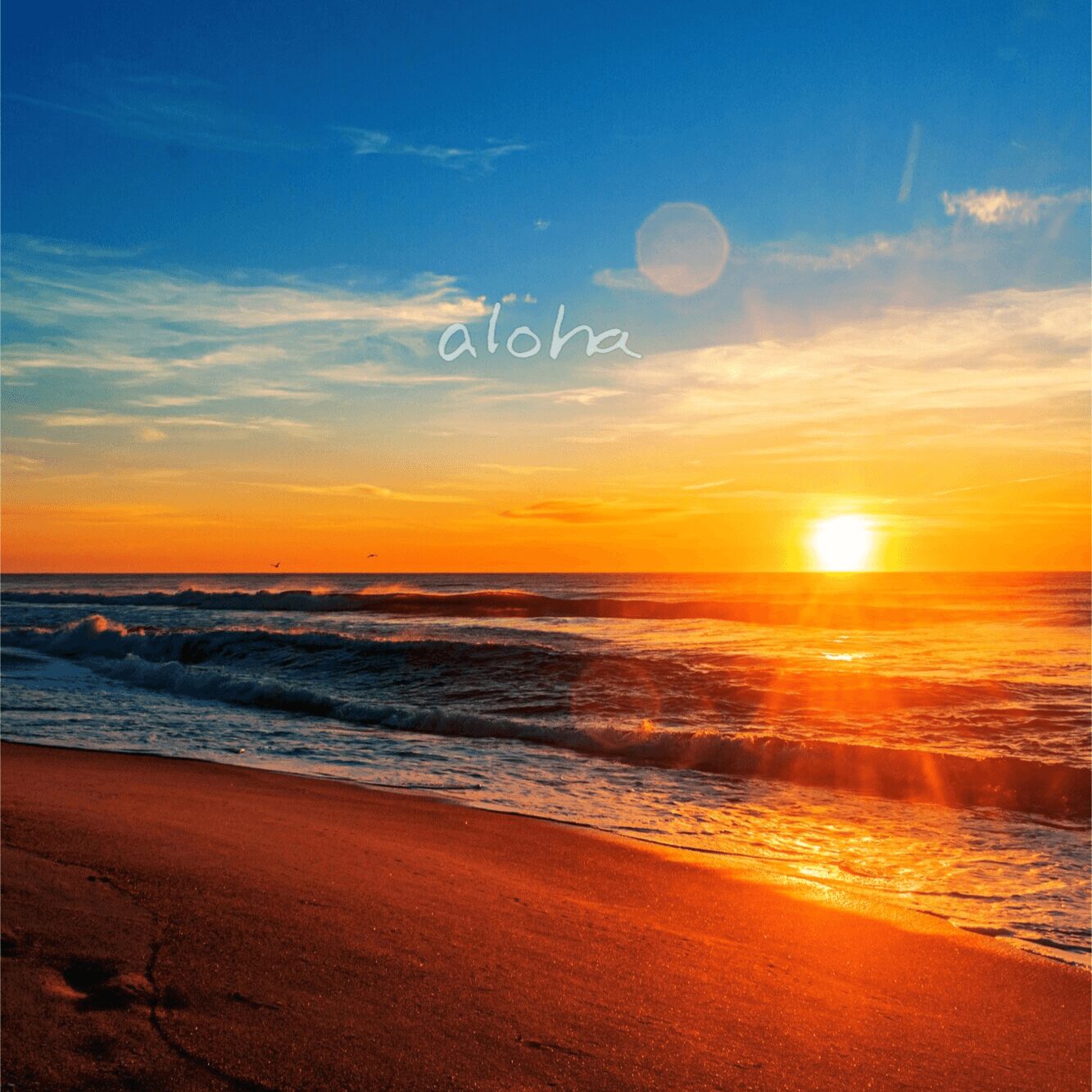 Sunset over ocean with waves and sandy beach, sky with clouds and a lens flare, warm colors, peaceful scene.
