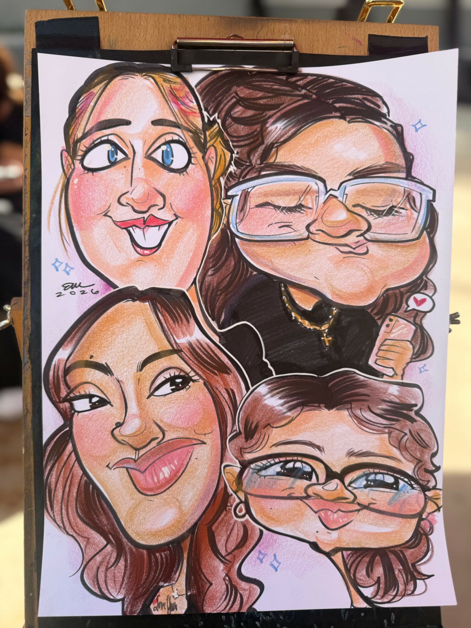 Four caricature portraits of women with exaggerated facial features, colorful makeup, and glasses, drawn on paper.