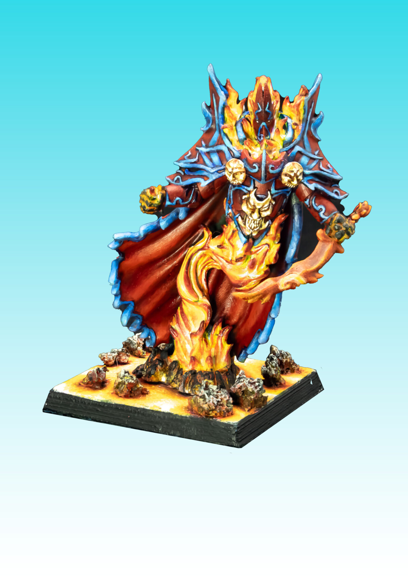 Miniature figure of a warrior with armor, a flowing cape, and a sword, standing on a detailed base with rocks and flames.
