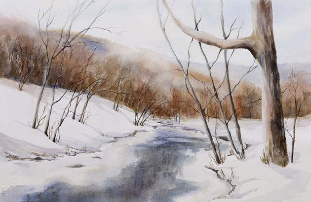 Snow-covered landscape with a partially frozen river, leafless trees, and distant hills under a cloudy sky.