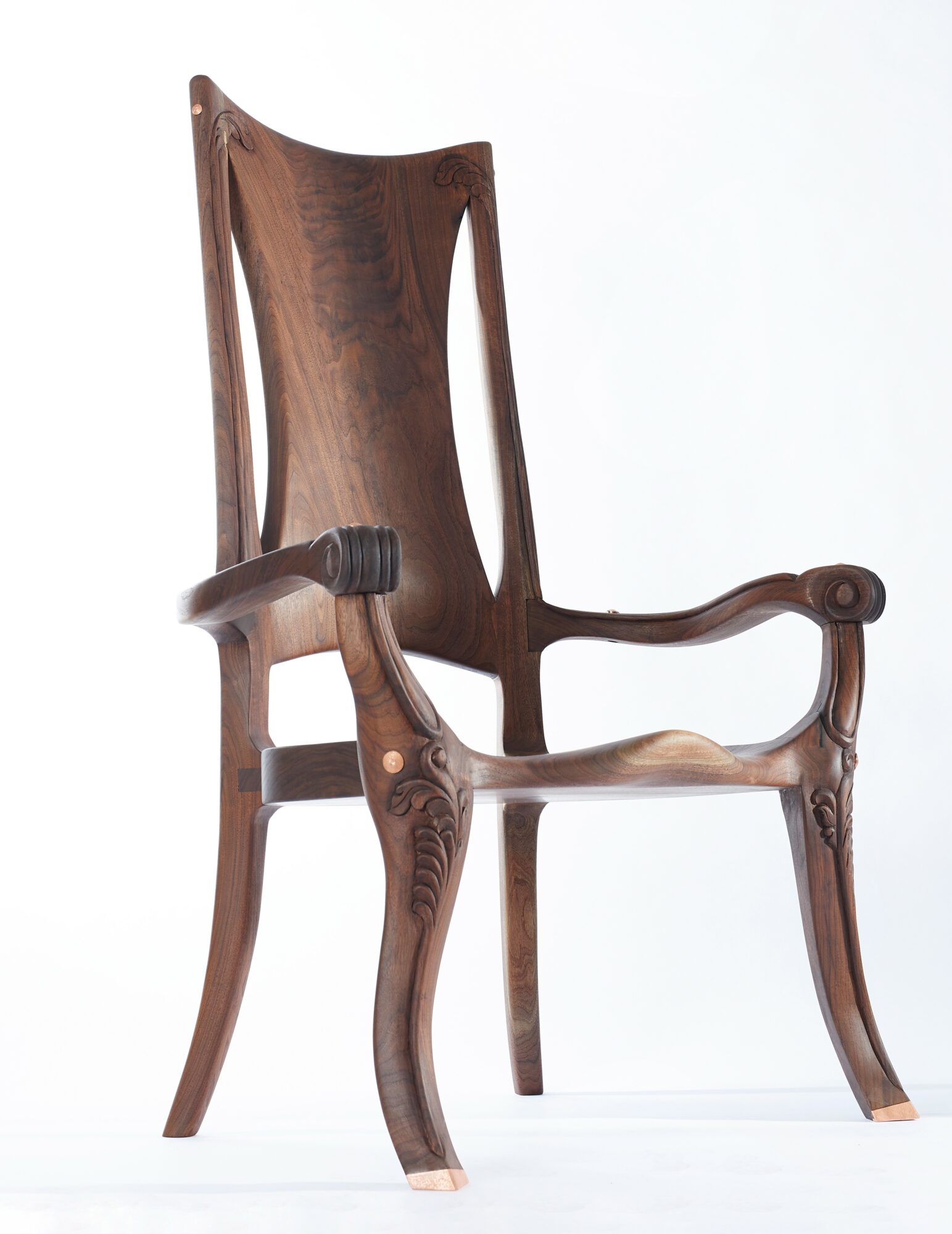 Wooden chair with curved armrests and tall backrest, set against a plain white background.