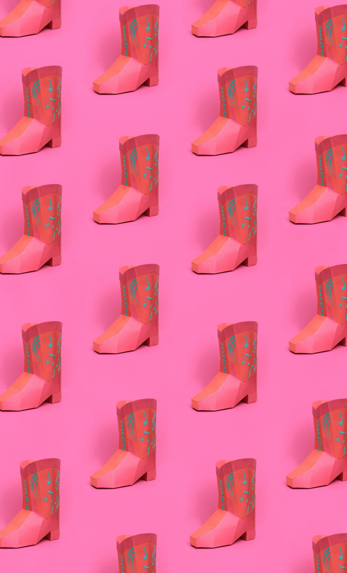 Repeated pattern of pink boots with colorful designs on a pink background.