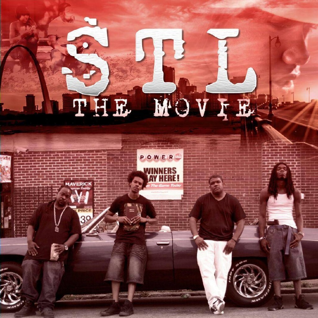 Four people standing in front of a car and a brick wall with a sign, with city skyline and sky in background