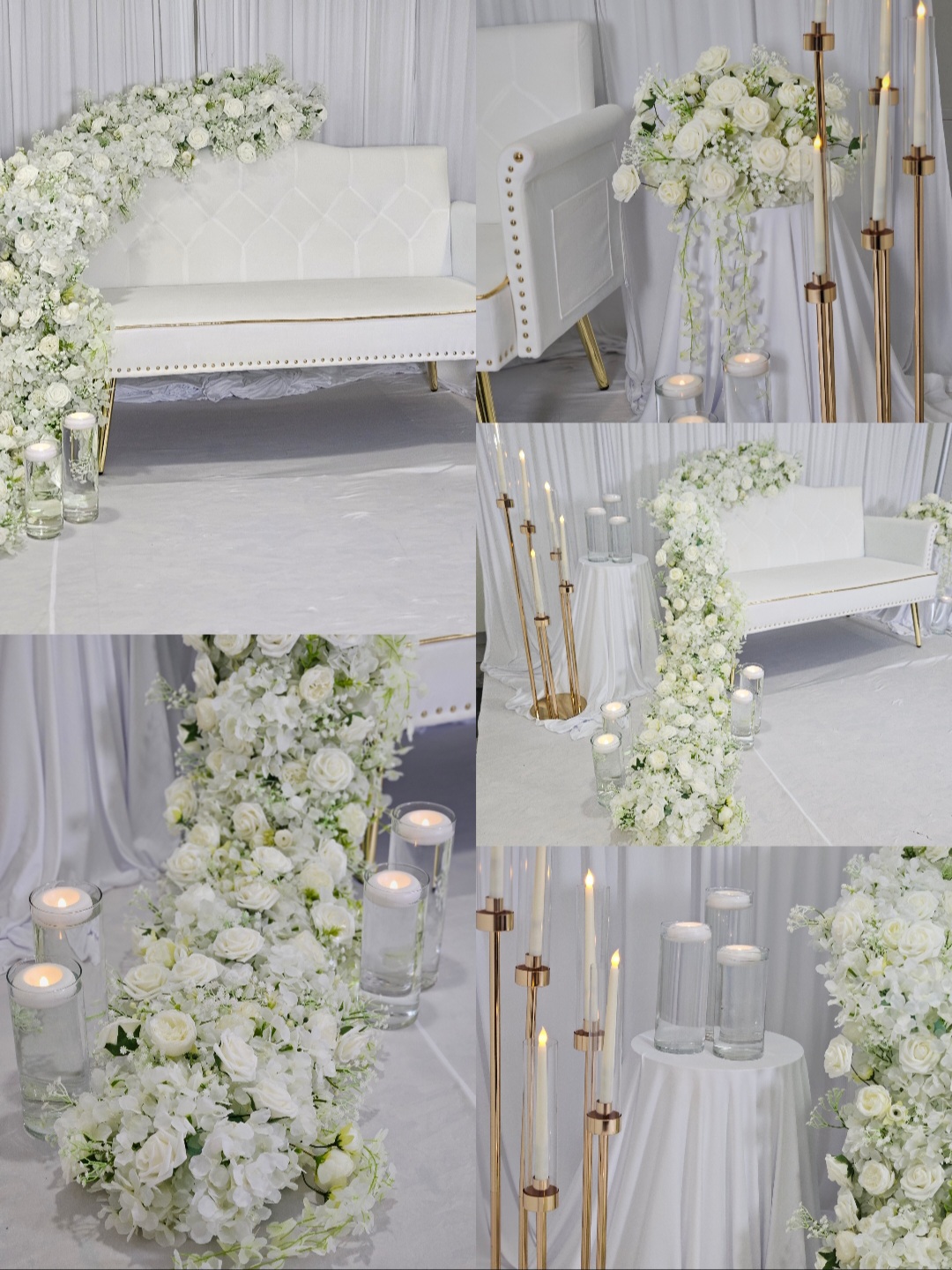 Elegant white floral arrangements with candles and gold accents decorate a light-colored room with sofas and drapes.