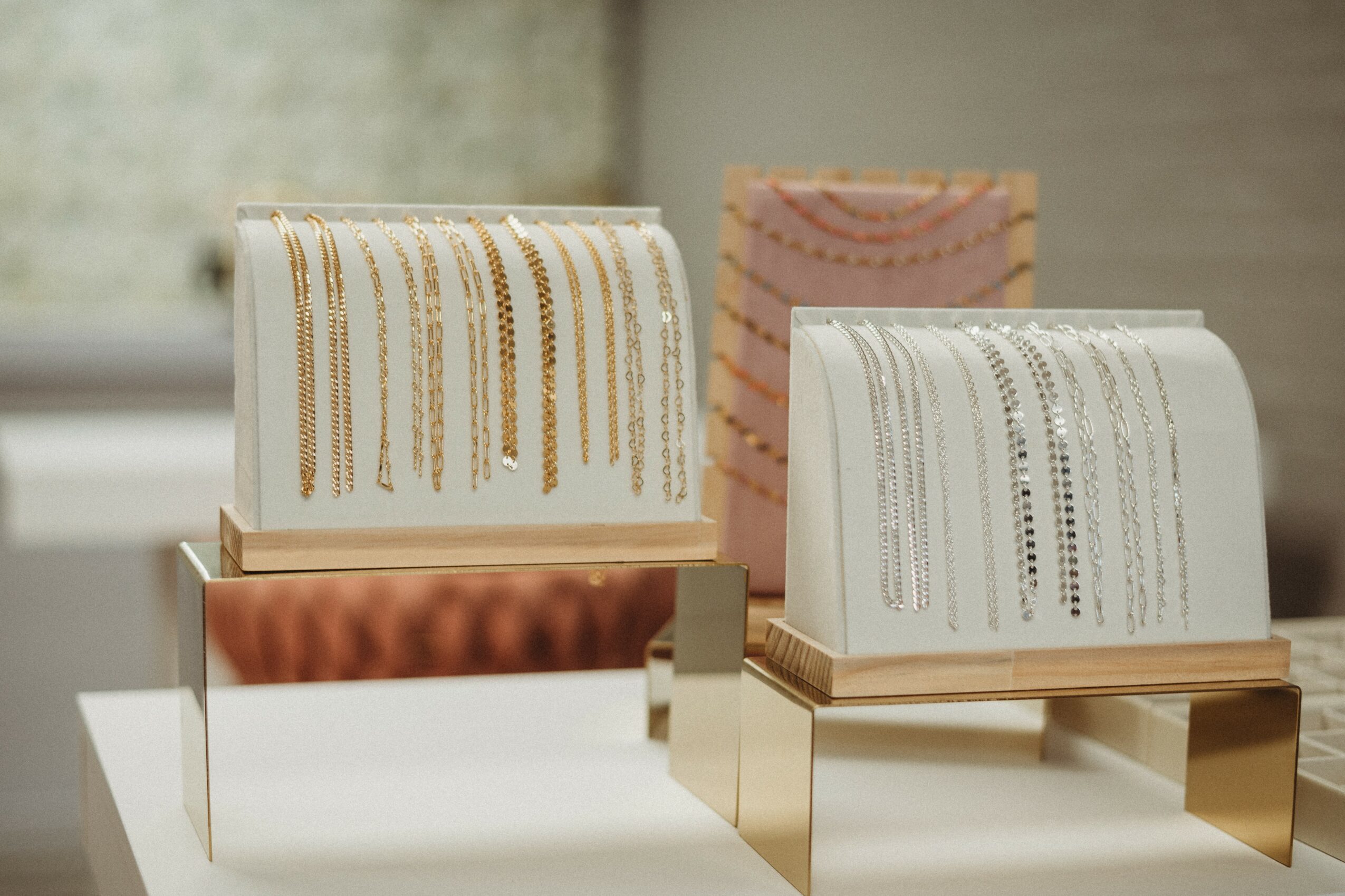 Two tissue boxes with decorative patterns on a table, one with gold stripes and the other with black dots, in a room.