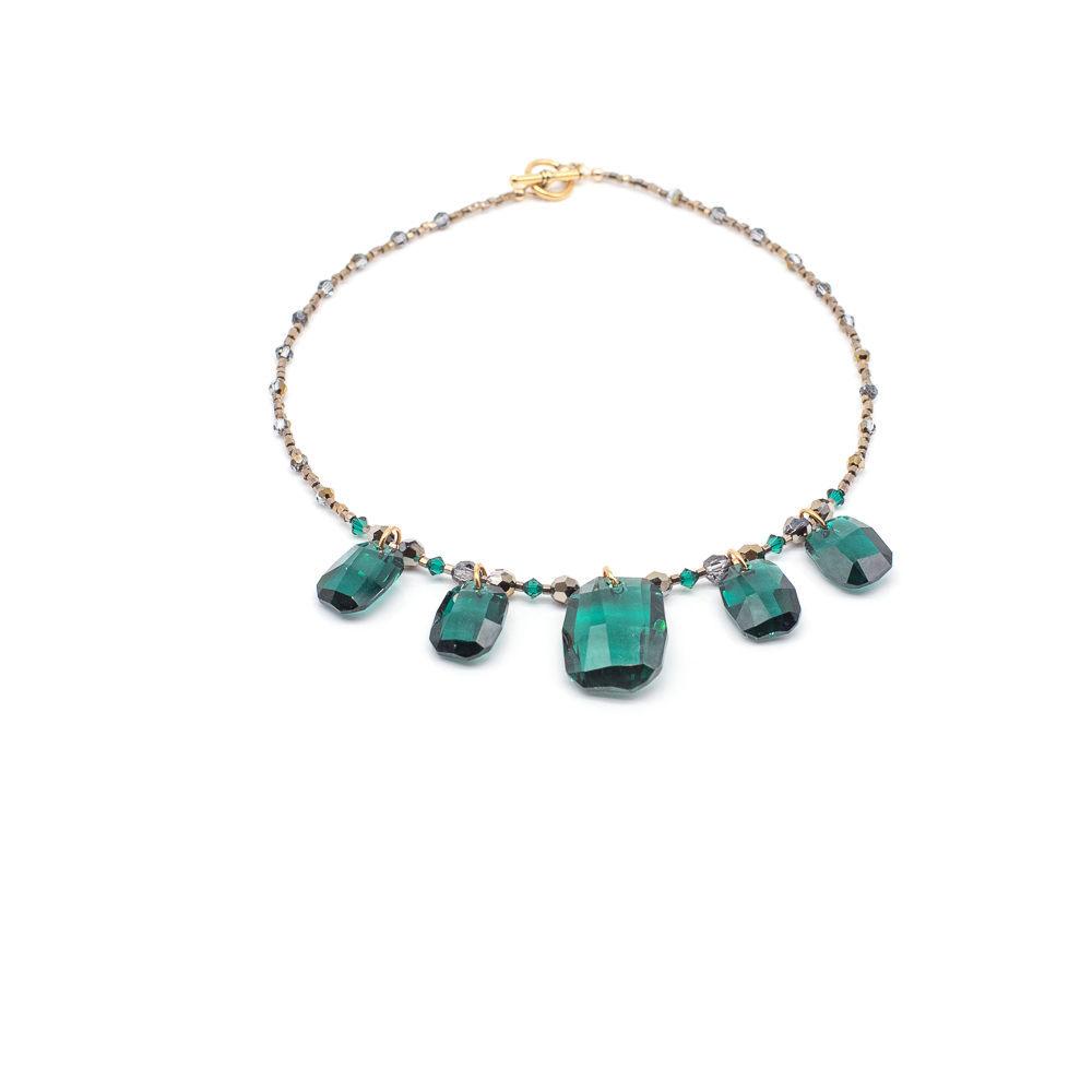 Necklace with five large green gemstones and small beads on a chain, displayed against a white background.