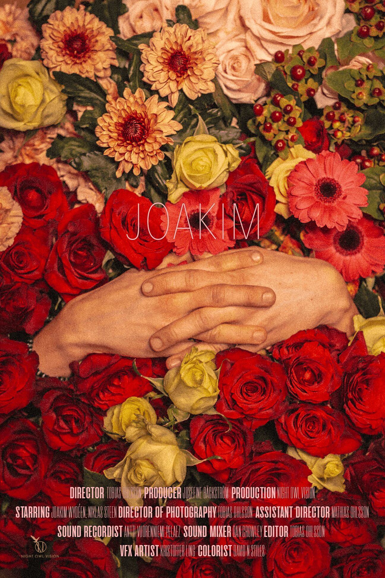 Hands resting on a bed of red, yellow, and pink flowers with text overlay.