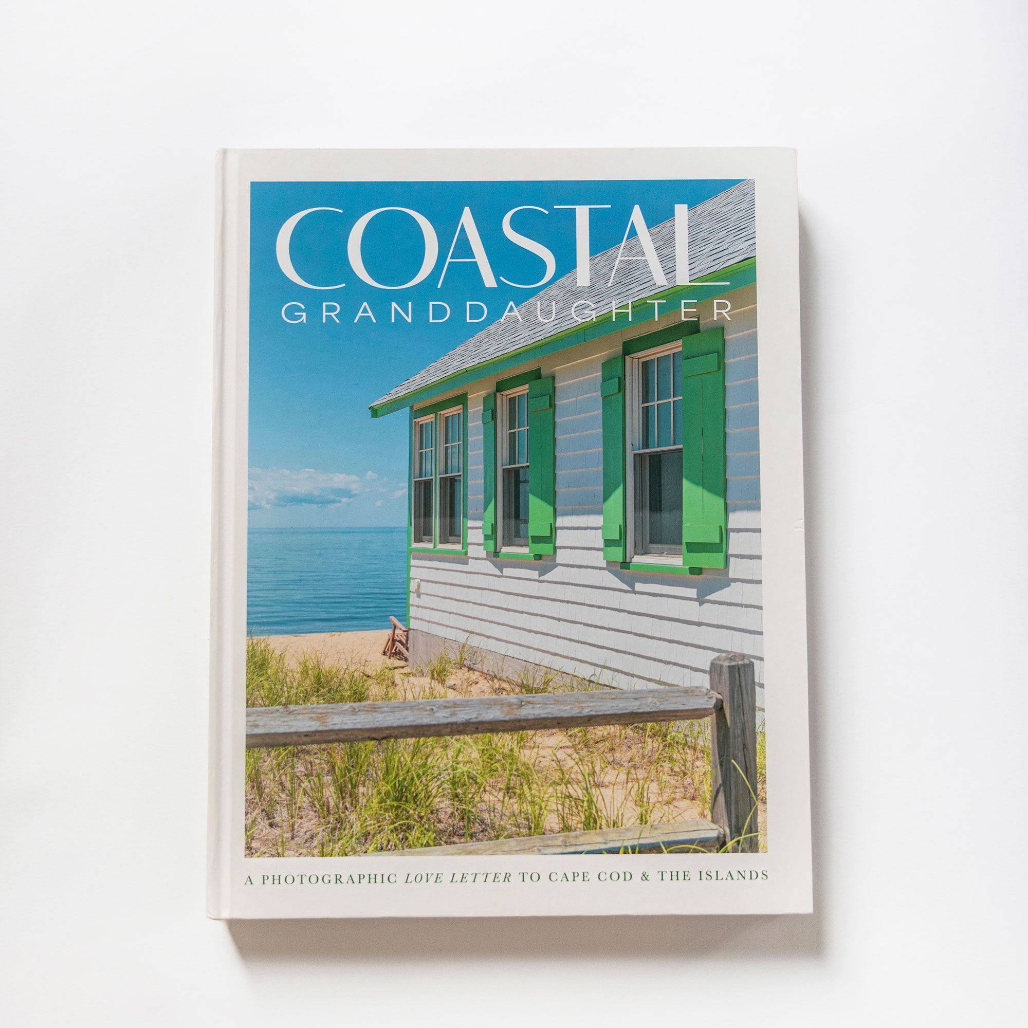Magazine titled 'COASTAL GRANDDAUGHTER' with a beach house on the cover, blue sky, and ocean in the background.