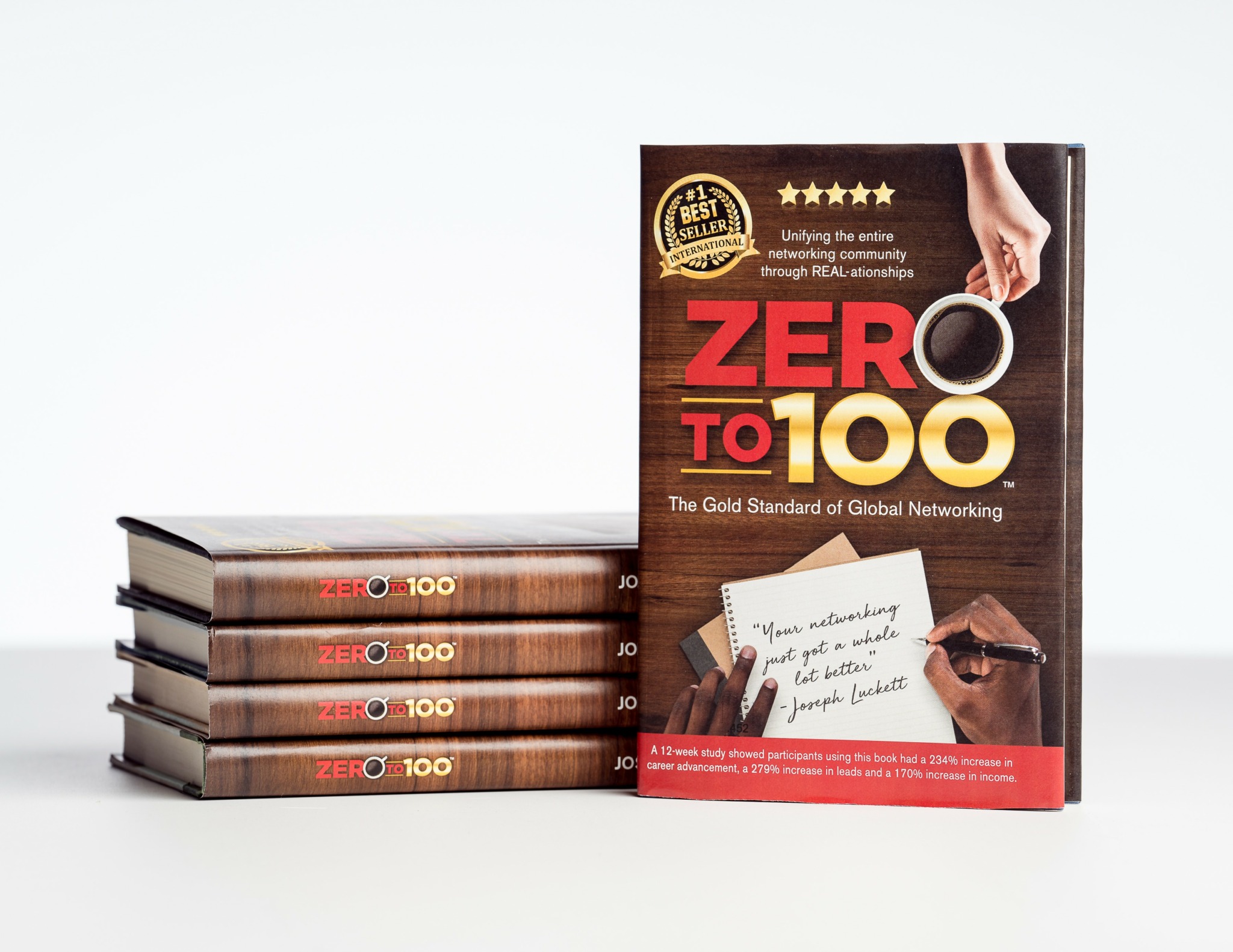 Stack of books titled 'Zero to 100' next to a standing book with a hand holding a pen and a note card, on a white background.