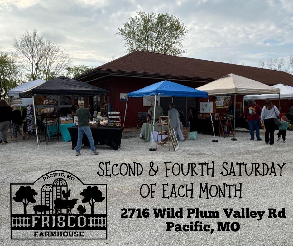 Outdoor market with tents and people in front of a red building, promoting a recurring event on Wild Plum Valley Road.