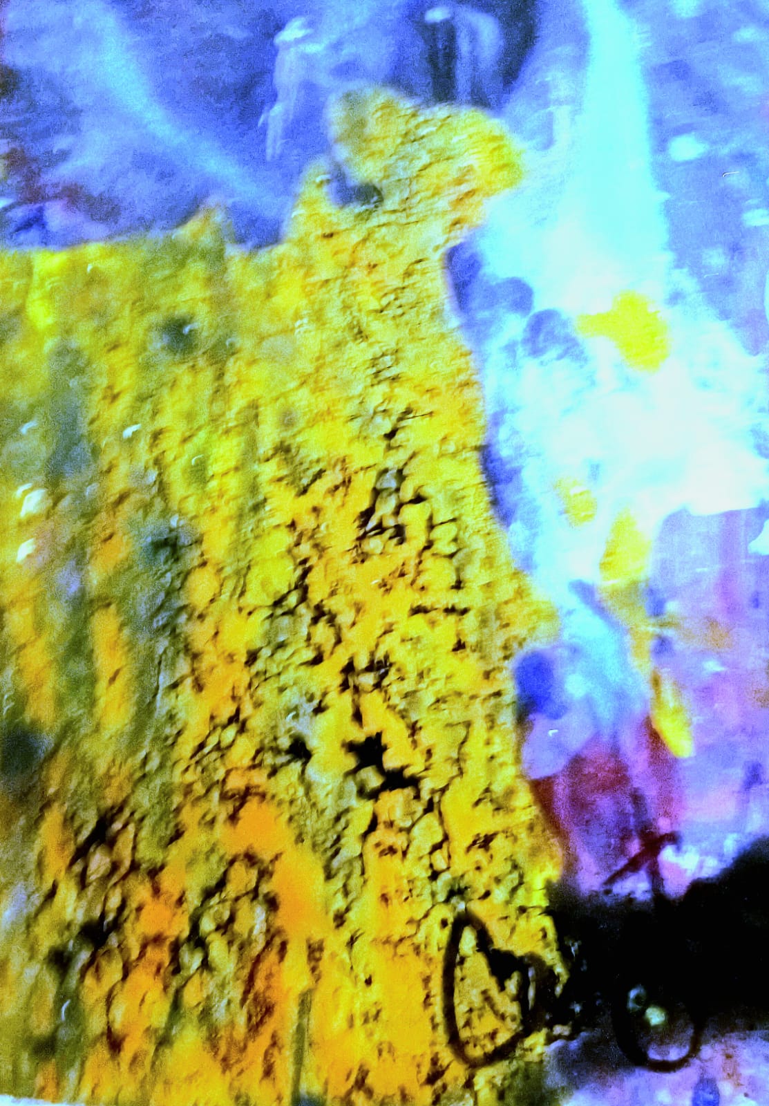 Abstract image with yellow, blue, and purple colors, featuring a textured yellow area and a dark shape at the bottom.