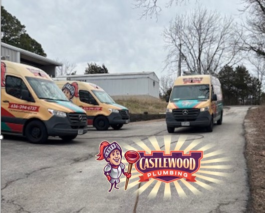 Three service vans parked outdoors with trees and buildings in the background, and a cartoon character holding a wrench in front of a logo.