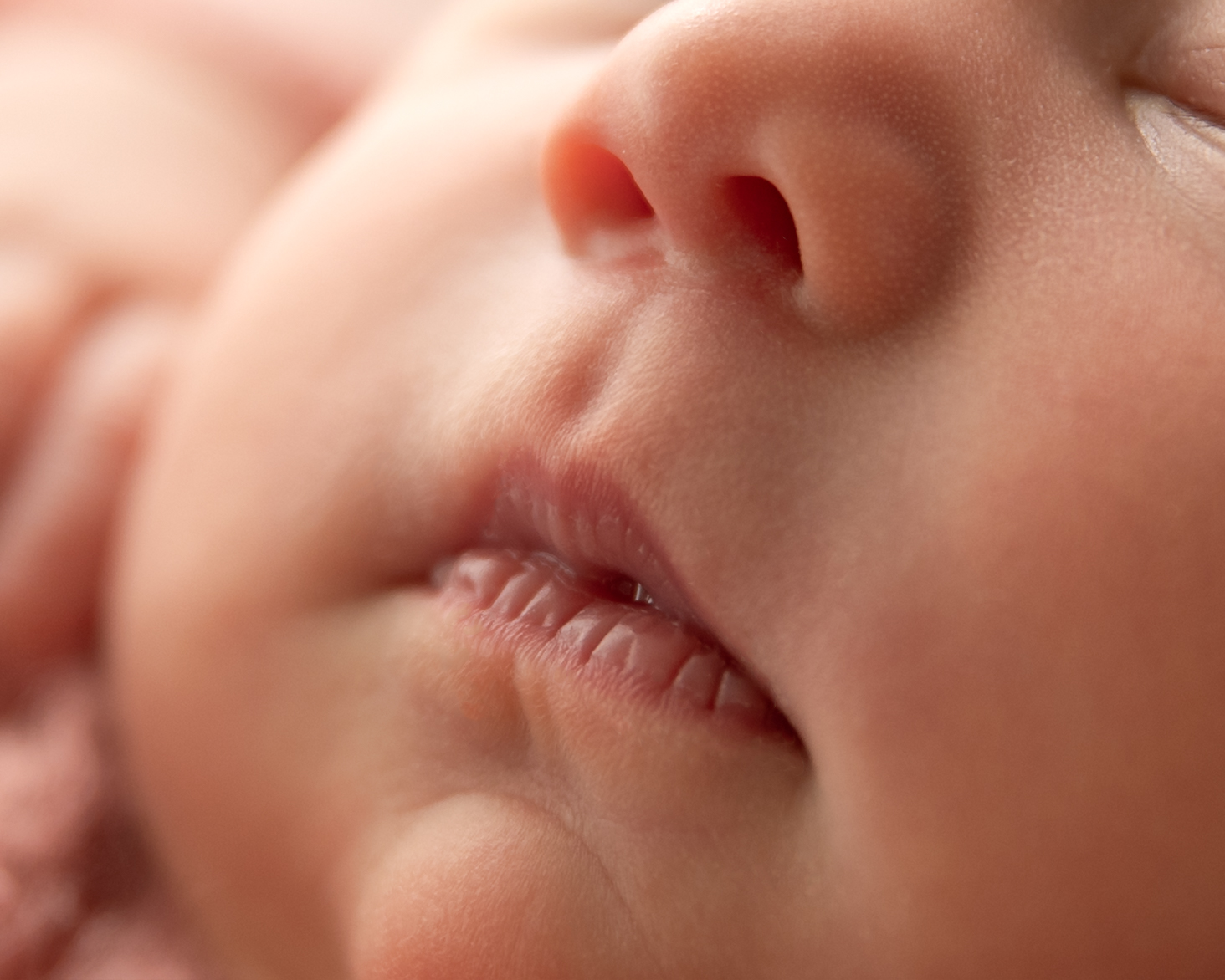 Close-up of a baby's nose and lips, showing soft skin and tiny features.